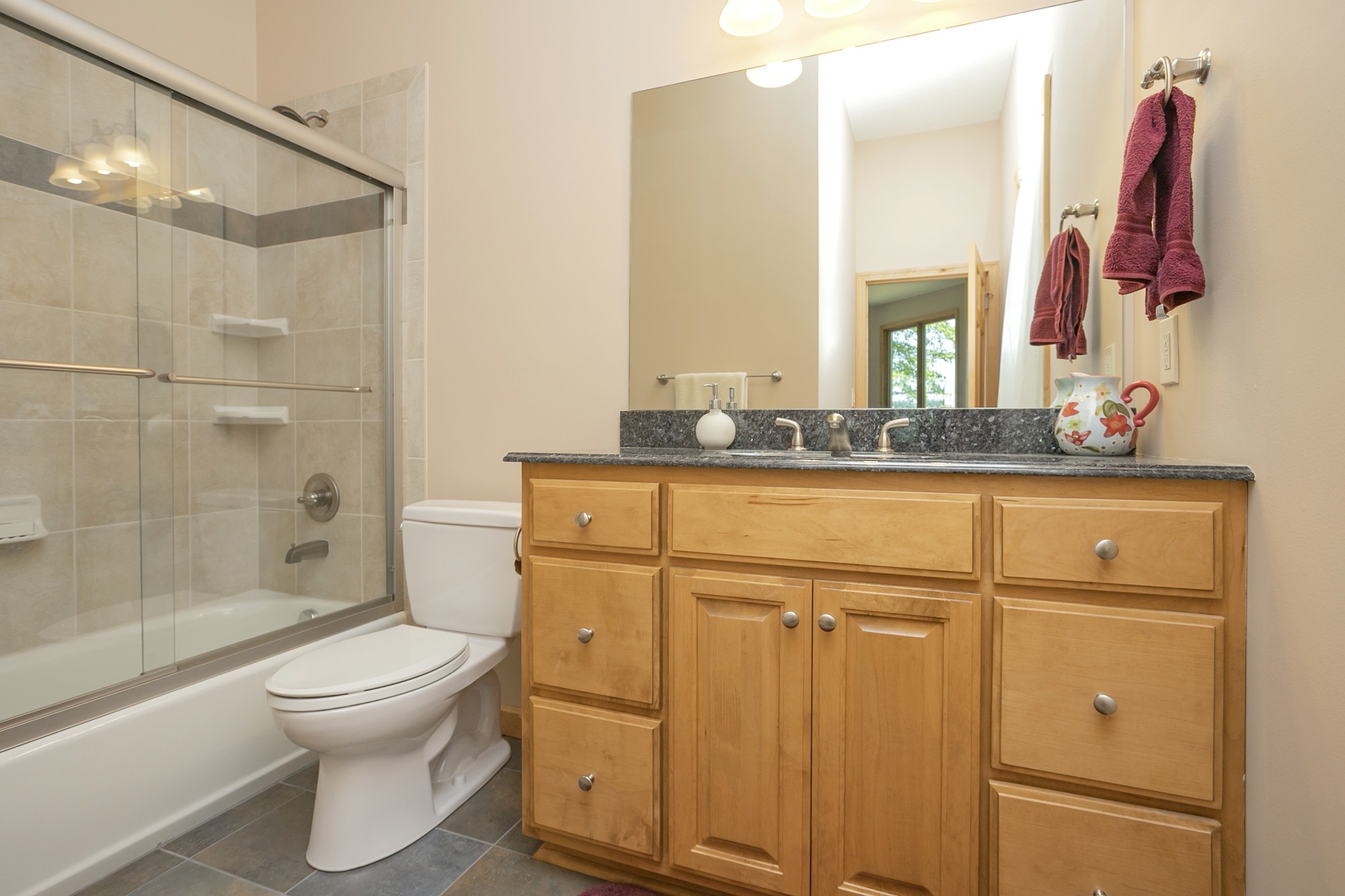 796 Thompson Road Pegram, TN 37143 - Photo 24 of 38 a bathroom with a granite countertop toilet sink and mirror