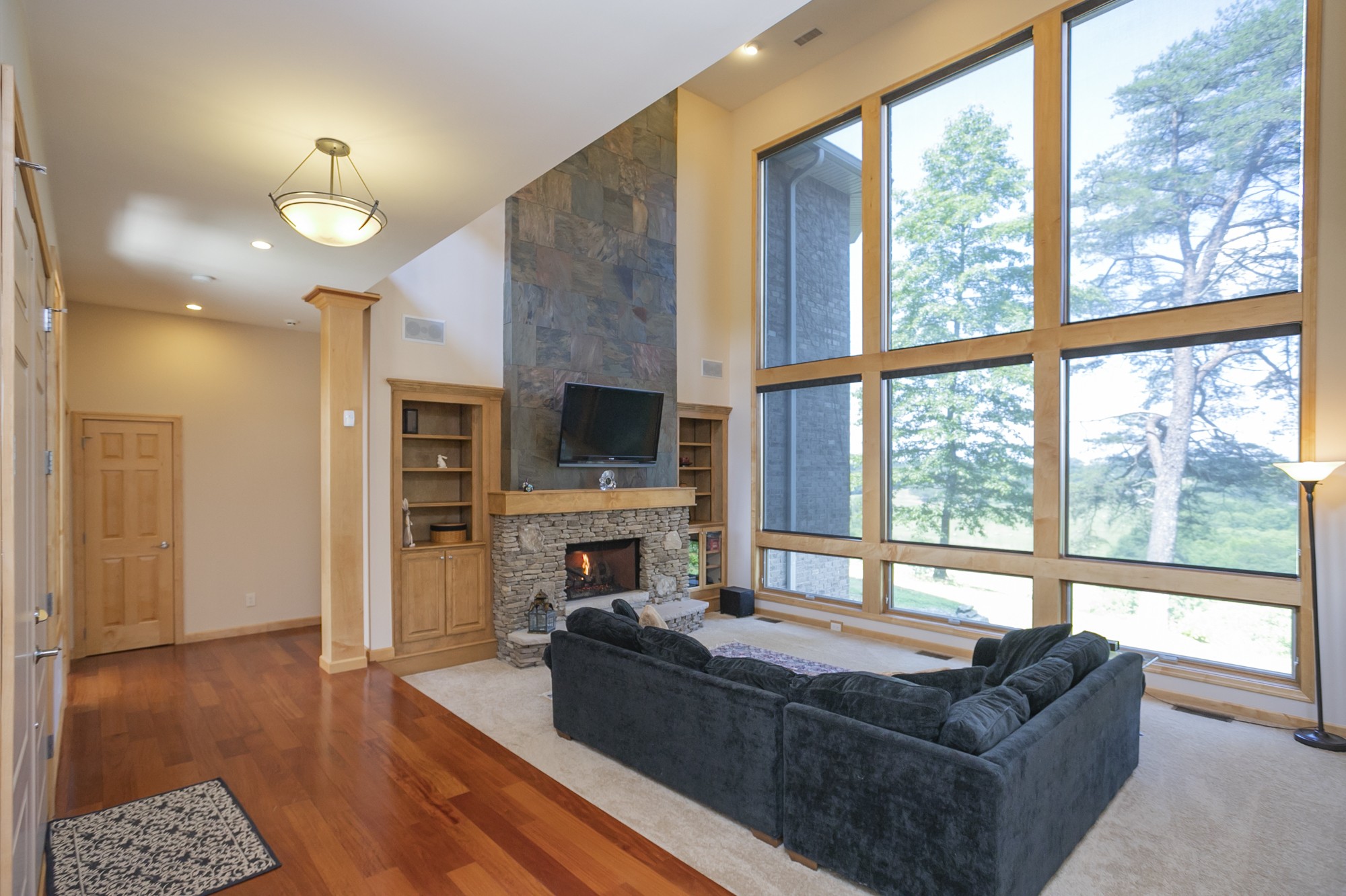 796 Thompson Road Pegram, TN 37143 - Photo 5 of 38 a living room with furniture large window and a flat screen tv