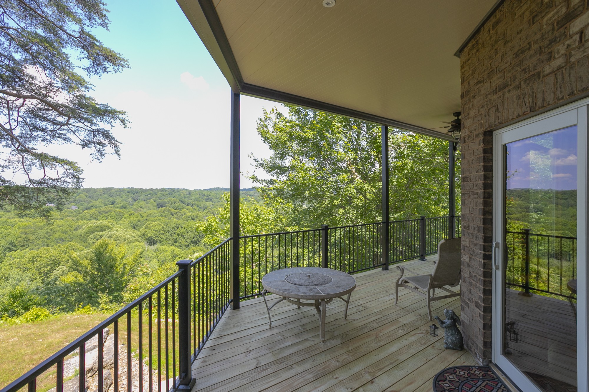 796 Thompson Road Pegram, TN 37143 - Photo 10 of 38 a view of a balcony with wooden floor and iron stairs