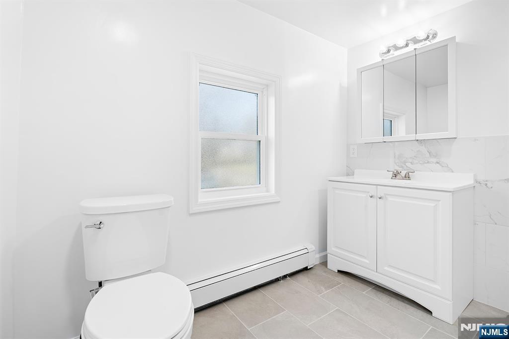 140 Park Avenue, Unit 2 Park Ridge, NJ 07656 - Photo 14 of 19 a bathroom with a sink toilet and vanity