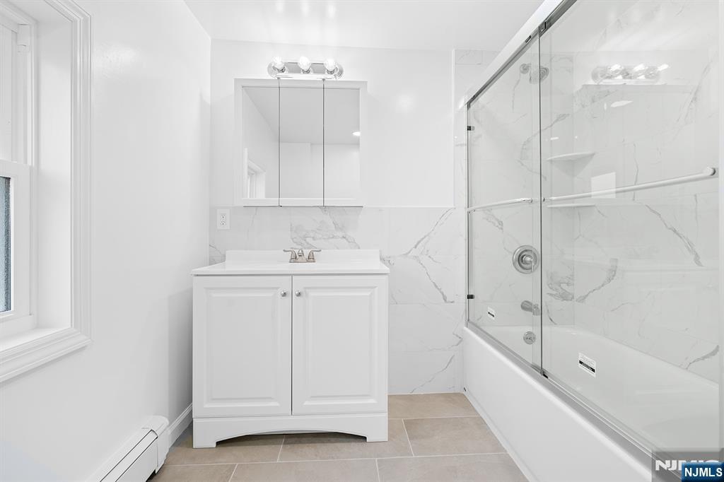 140 Park Avenue, Unit 2 Park Ridge, NJ 07656 - Photo 15 of 19 a bathroom with a sink a mirror and a bathtub