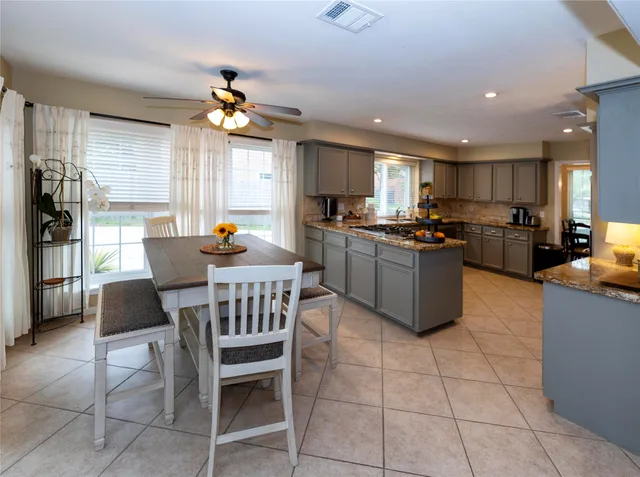 a kitchen with granite countertop a sink a counter top space appliances and cabinets