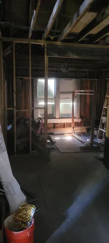 a brick building with a tree in the yard