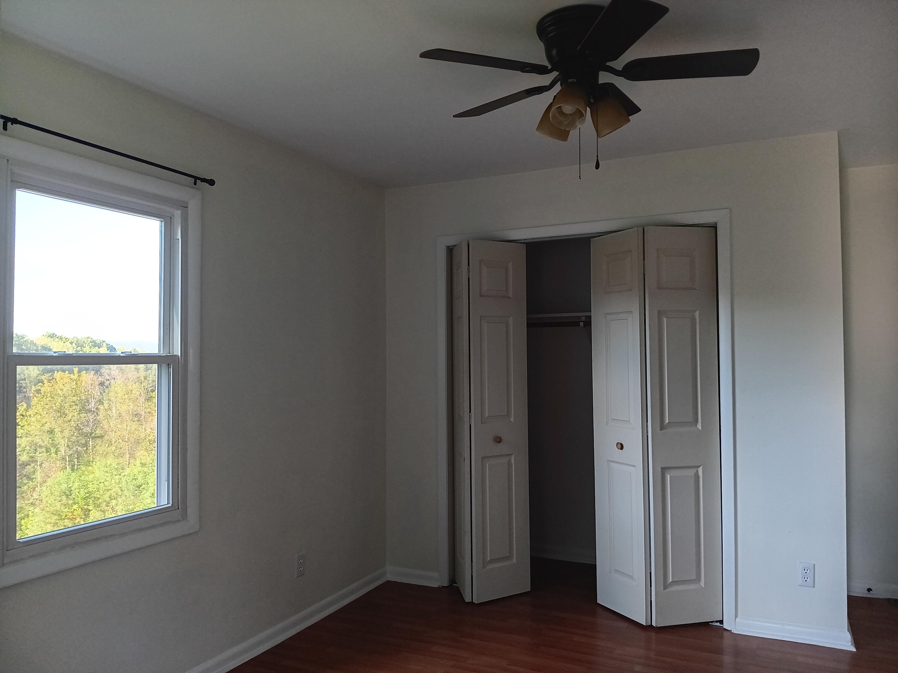 6000 Ferrum Mountain Road Callaway, VA 24067 - Photo 43 of 58 a view of empty room with wooden floor and fan