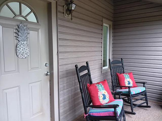 a view of a kitchen area with furniture and wooden floor