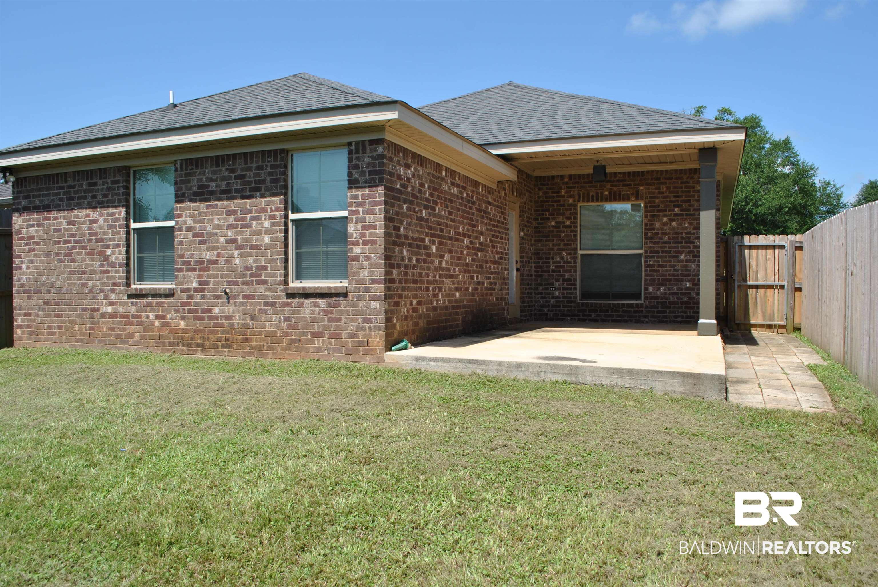 2161 Spring Grove West Mobile, AL 36695 - Photo 27 of 31 Back of property with a patio area, roof with shingles, and brick siding