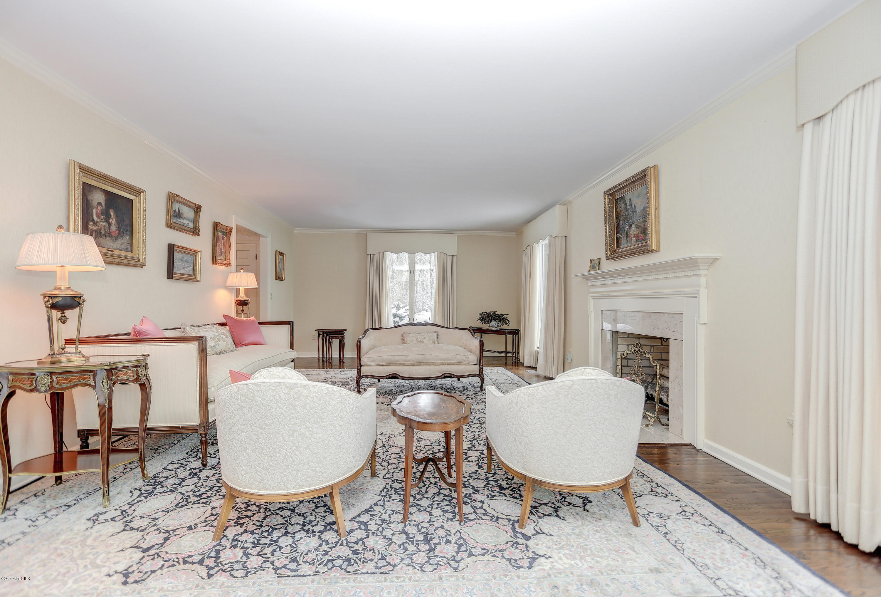 73 Taconic Road Greenwich, CT 06831 - Photo 6 of 24 a living room with furniture a fireplace and a table