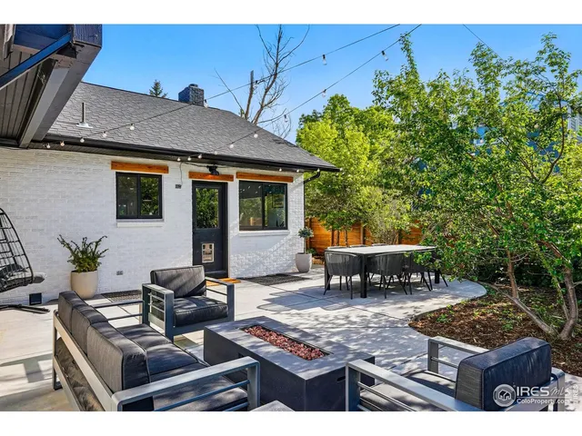a open kitchen with stainless steel appliances kitchen island hardwood floor sink stove and living room