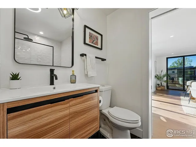 a bathroom with a sink a mirror and shower