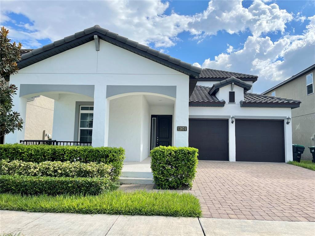 a front view of a house with garden