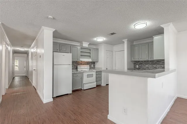 a kitchen with stainless steel appliances a sink and a refrigerator