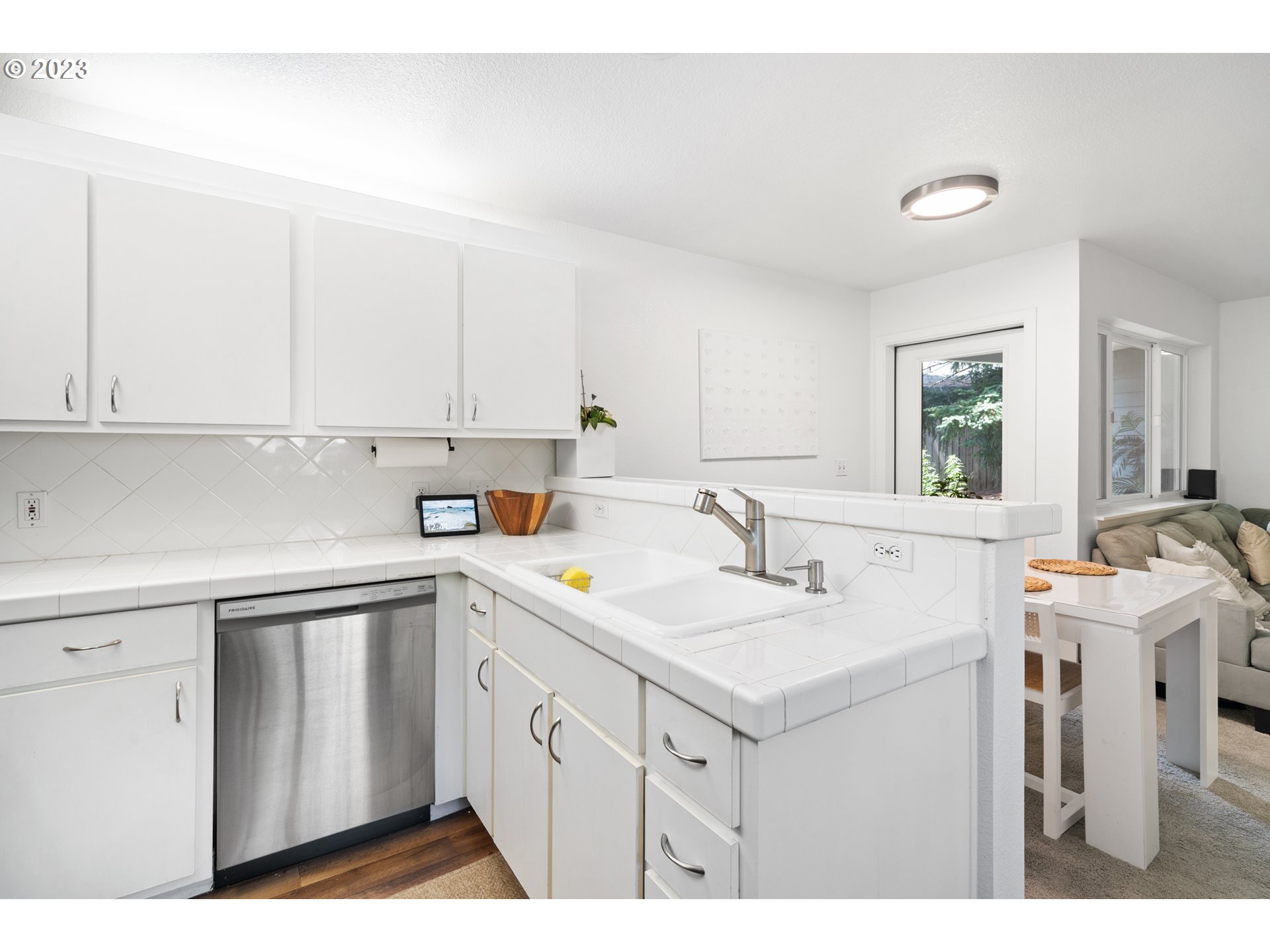 5225 Jean Road, Unit 309 Lake Oswego, OR 97035 - Photo 11 of 26 a kitchen with a sink cabinets and window
