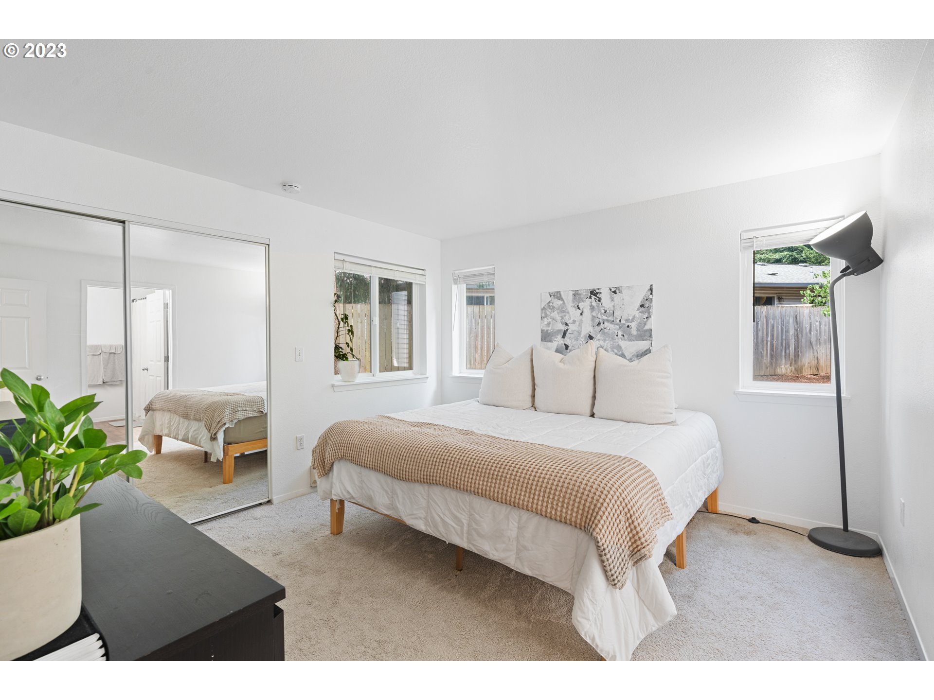5225 Jean Road, Unit 309 Lake Oswego, OR 97035 - Photo 13 of 26 a bedroom with a large bed and potted plant