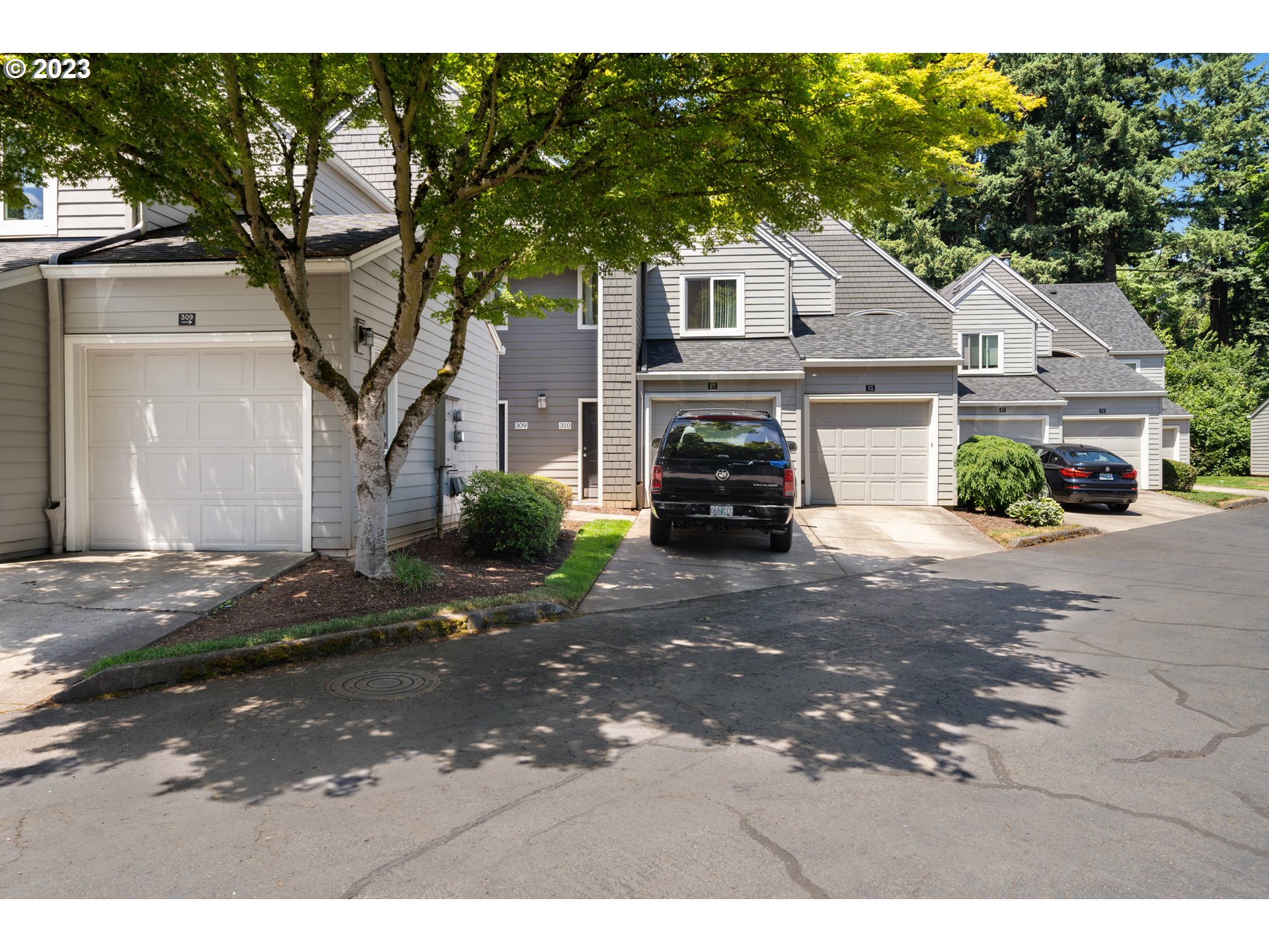 5225 Jean Road, Unit 309 Lake Oswego, OR 97035 - Photo 22 of 26 a front view of a house with a yard and garage
