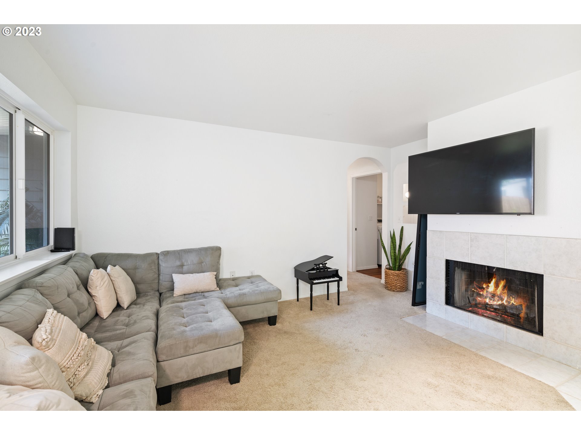 5225 Jean Road, Unit 309 Lake Oswego, OR 97035 - Photo 3 of 26 a living room with furniture a flat screen tv and a fireplace