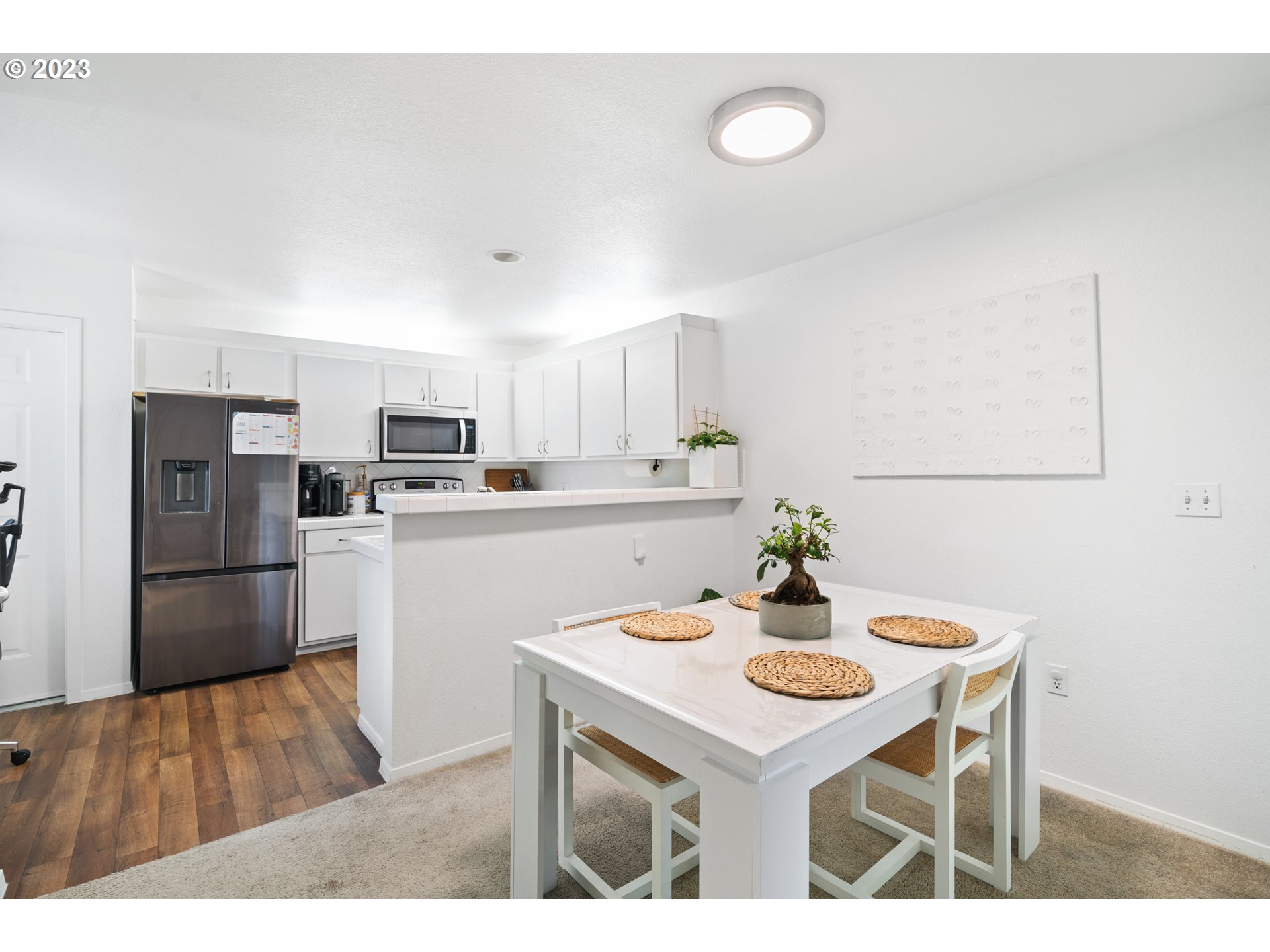 5225 Jean Road, Unit 309 Lake Oswego, OR 97035 - Photo 5 of 26 a kitchen with refrigerator and white table