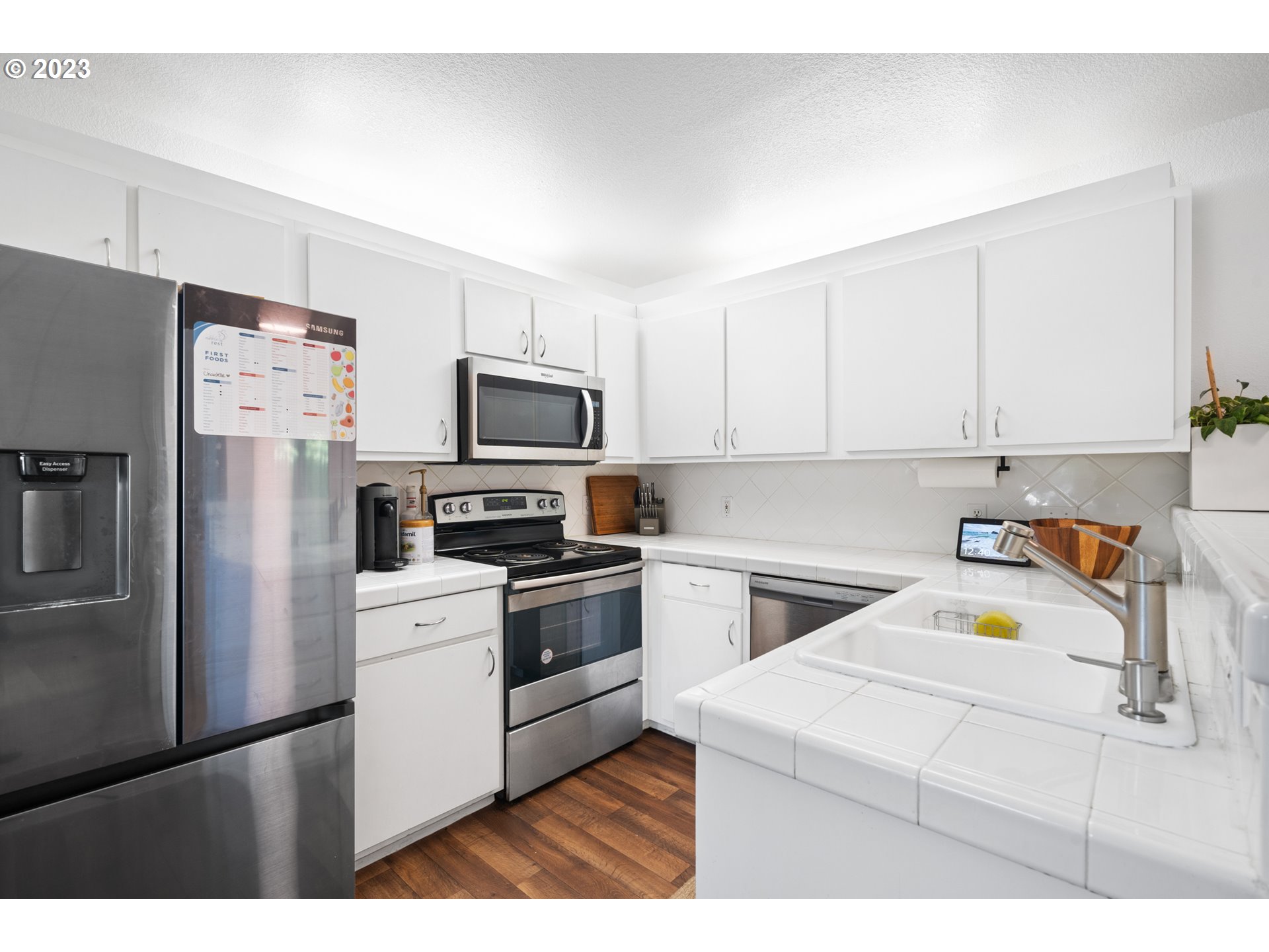 5225 Jean Road, Unit 309 Lake Oswego, OR 97035 - Photo 9 of 26 a kitchen with a refrigerator stove and microwave