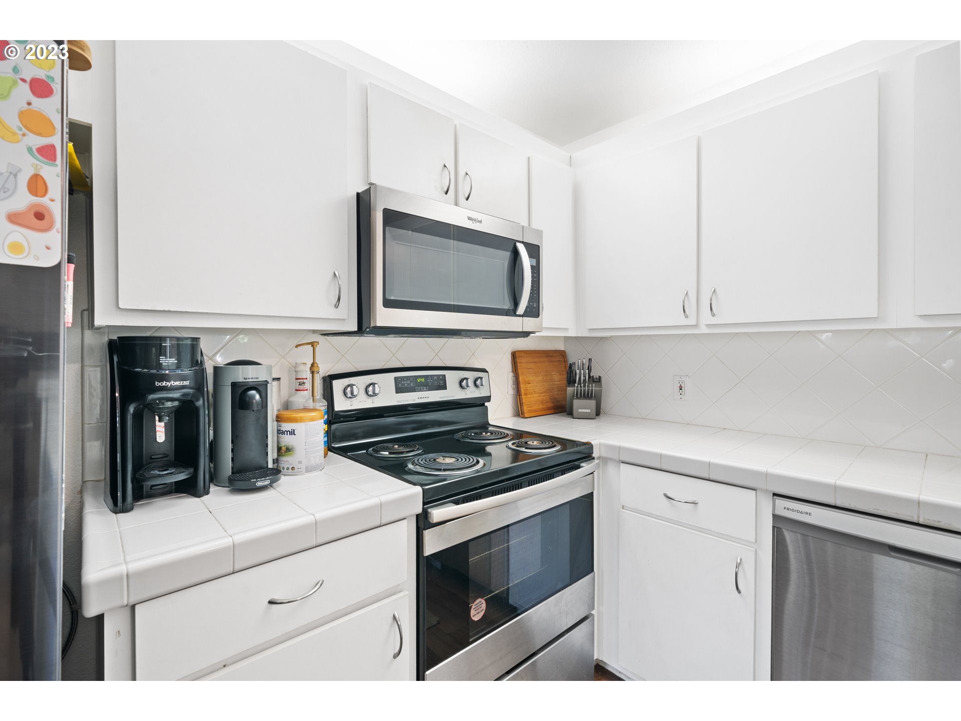 5225 Jean Road, Unit 309 Lake Oswego, OR 97035 - Photo 10 of 26 a kitchen with cabinets white stainless steel appliances and a sink