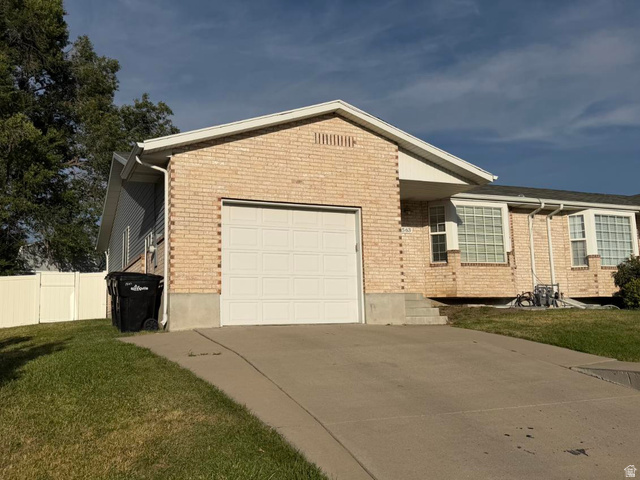 1563 South 600 East Springville, UT 84663 - Photo 2 of 30 Light brick exterior with a white garage door