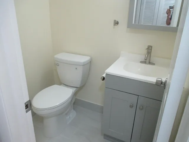 a white toilet sitting next to a white sink