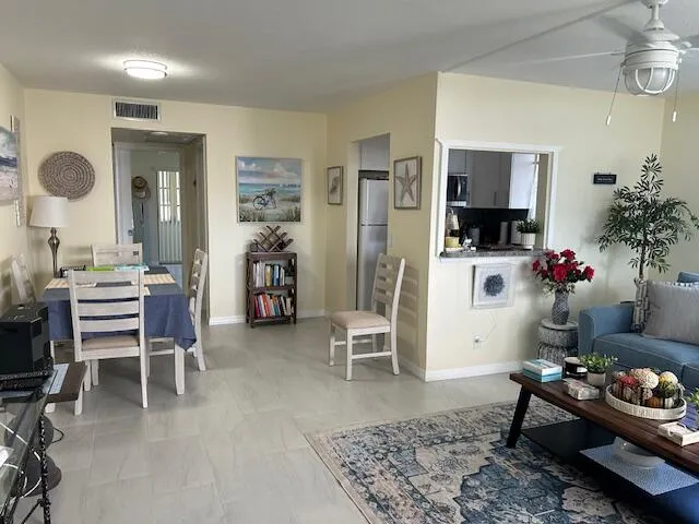 a living room with furniture and a potted plant