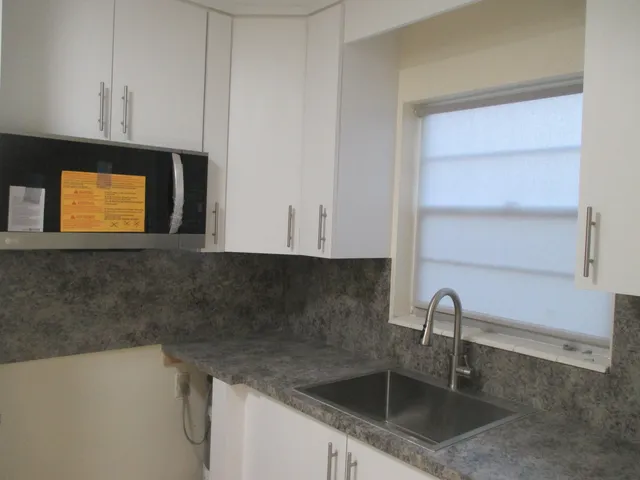a kitchen with a sink and cabinets