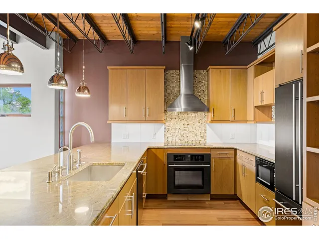a kitchen with a sink and wooden cabinets
