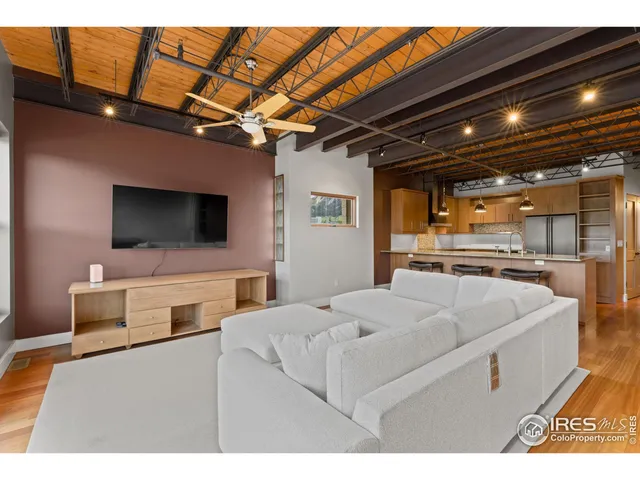 a living room with furniture and a view of the kitchen
