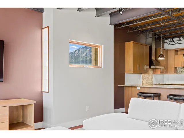 a open kitchen with a dishwasher and white countertops with wooden floor