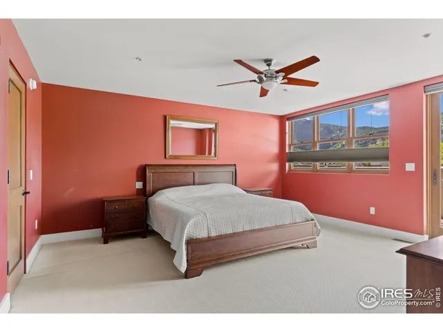 a bedroom with a bed and a ceiling fan