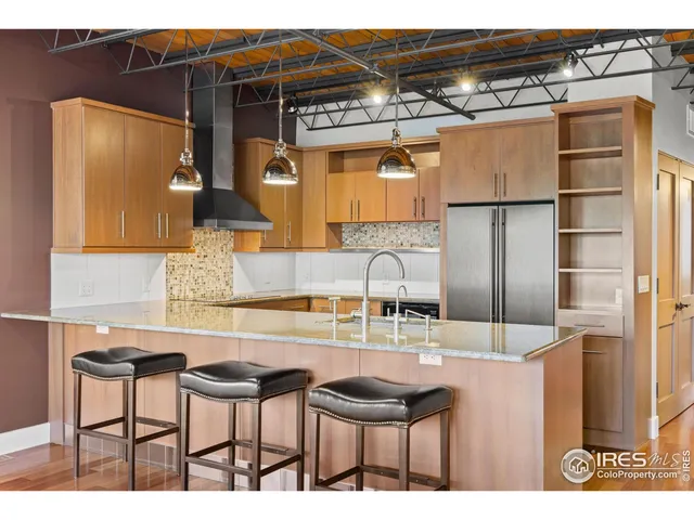a kitchen with stainless steel appliances granite countertop a sink and cabinets