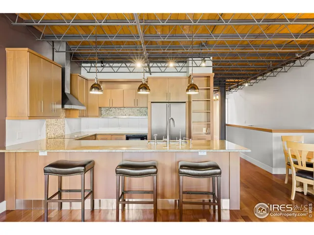 a kitchen with stainless steel appliances granite countertop a sink and cabinets