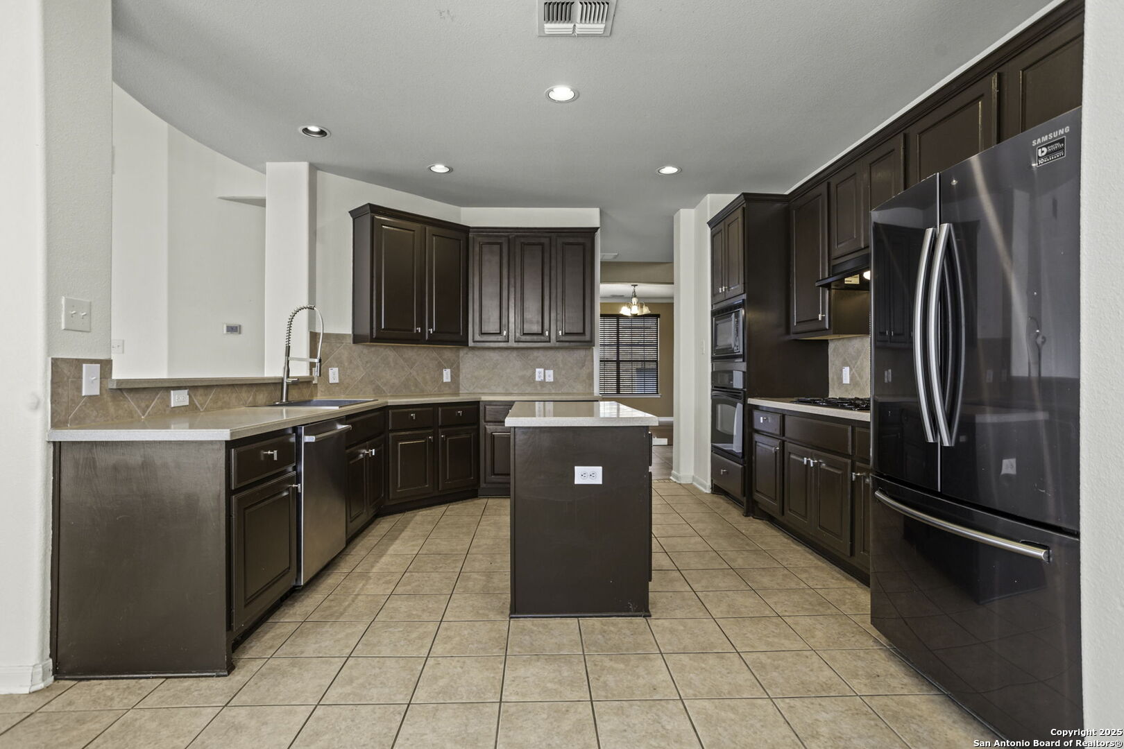 3415 Highline Trail San Antonio, TX 78261 - Photo 3 of 21 a kitchen with stainless steel appliances granite countertop refrigerator a sink and dishwasher