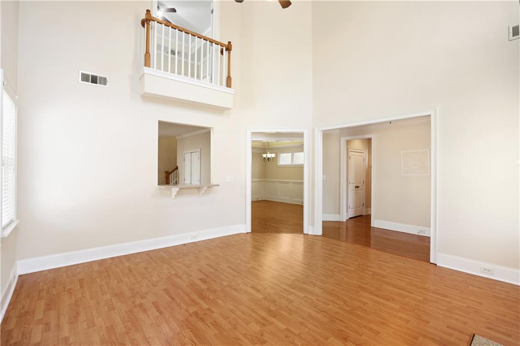 337 Myrtle Trace Lane Suwanee, GA 30024 - Photo 5 of 14 a view of an empty room with wooden floor and a bathroom