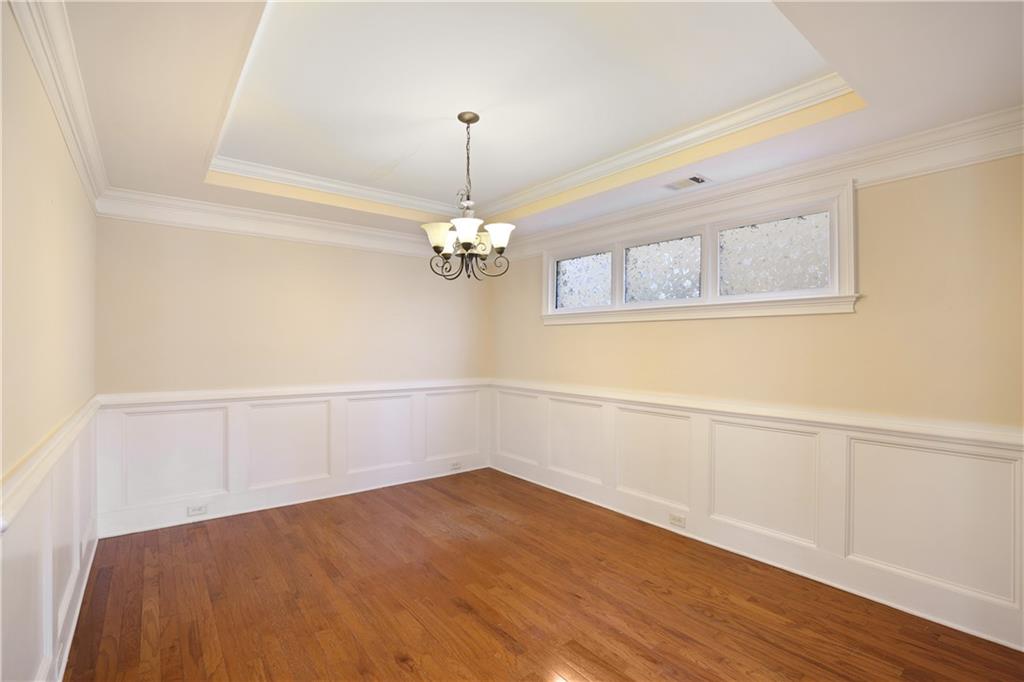 337 Myrtle Trace Lane Suwanee, GA 30024 - Photo 6 of 14 a view of a room with wooden floor and chandelier