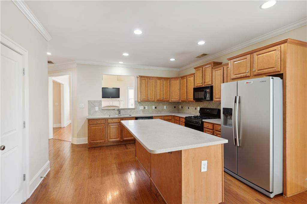 337 Myrtle Trace Lane Suwanee, GA 30024 - Photo 8 of 14 a kitchen with stainless steel appliances a refrigerator and a stove top oven