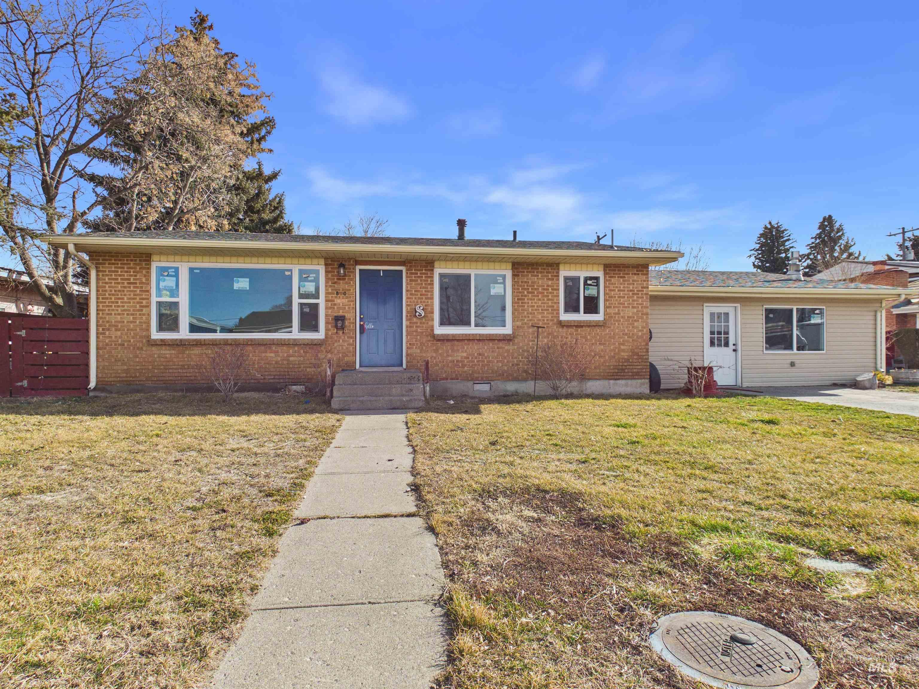 810 South D Street Rupert, ID 83350 - Photo 1 of 23 Ranch-style home with brick siding, a front yard, entry steps, and crawl space