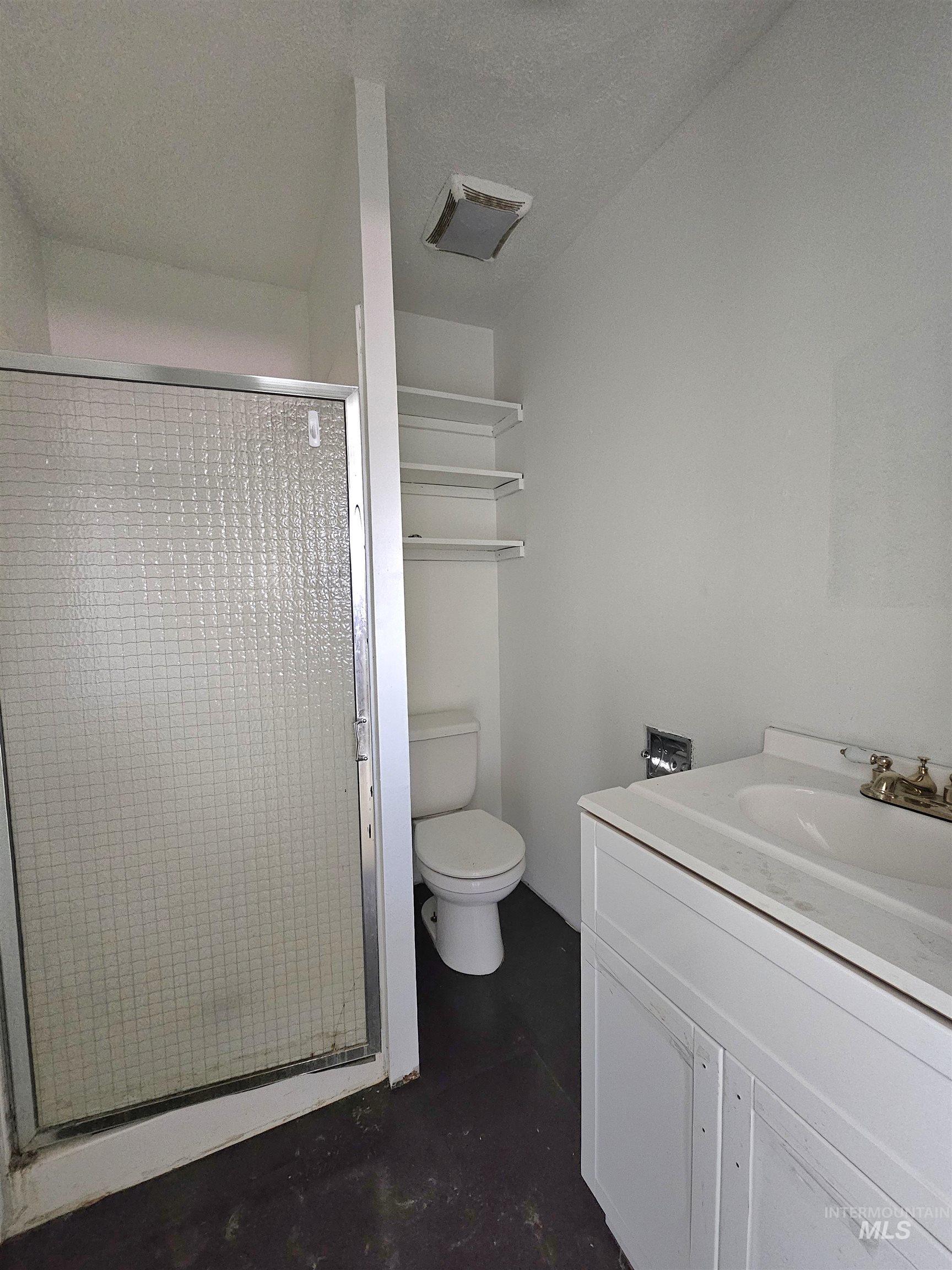 810 South D Street Rupert, ID 83350 - Photo 13 of 23 Full bath with vanity, a shower stall, and finished concrete floors