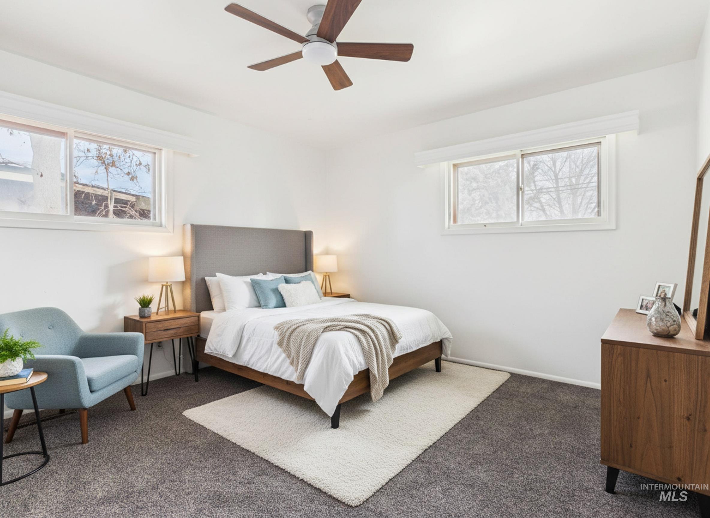 810 South D Street Rupert, ID 83350 - Photo 21 of 23 Bedroom featuring multiple windows, dark carpet, and a ceiling fan