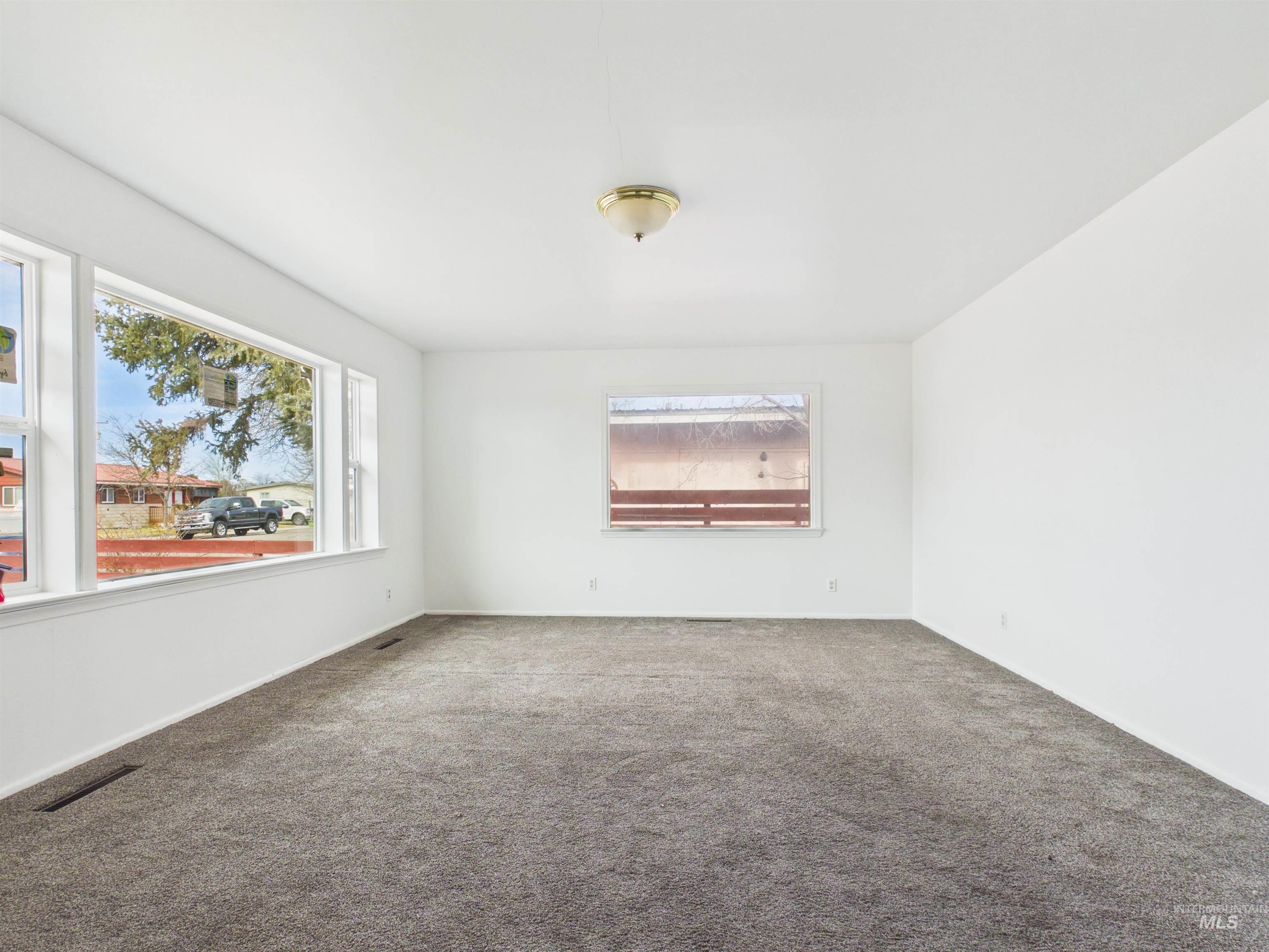 810 South D Street Rupert, ID 83350 - Photo 3 of 23 Empty room with carpet flooring and baseboards