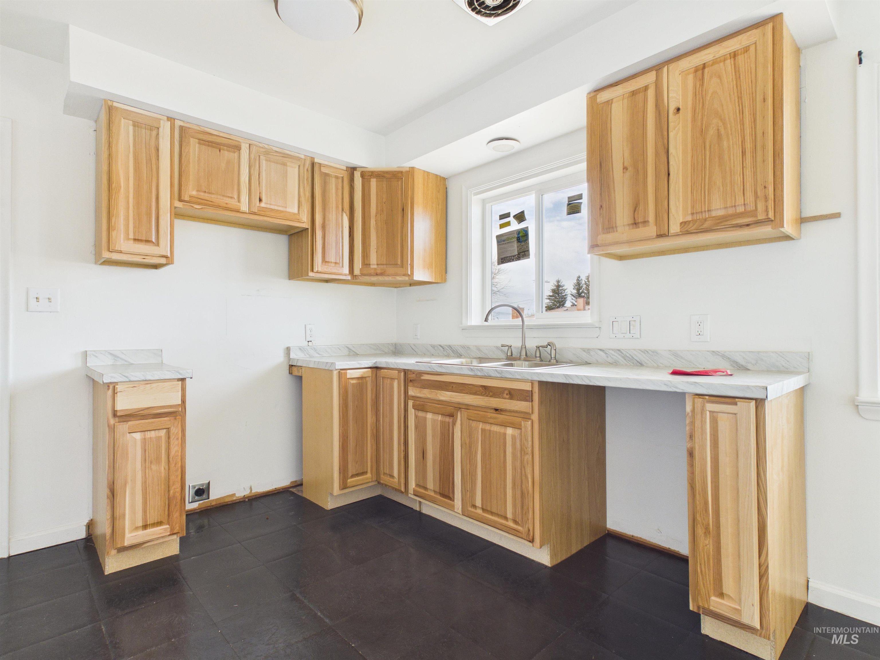810 South D Street Rupert, ID 83350 - Photo 5 of 23 Kitchen with light countertops and light wood finish cabinets