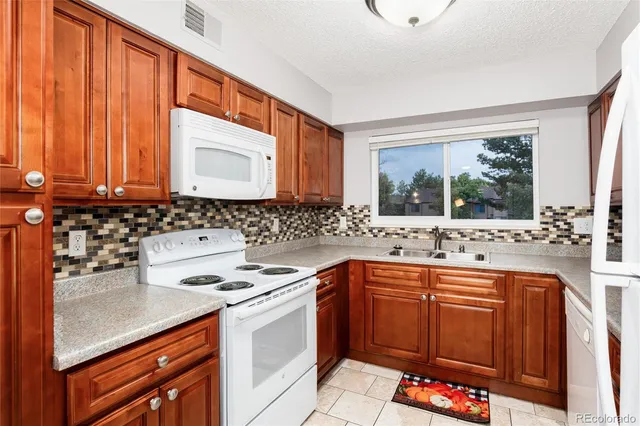 a kitchen with stainless steel appliances a sink stove and cabinets