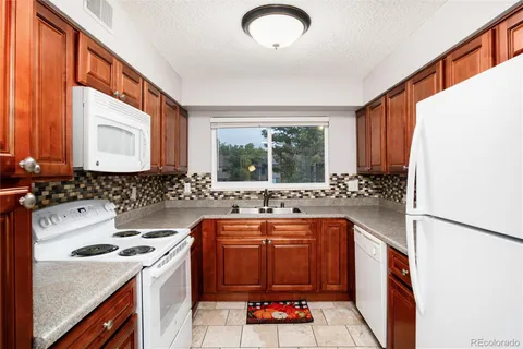 a kitchen with a sink stove and cabinets