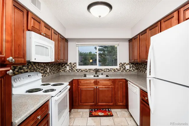 a kitchen with a sink stove and cabinets