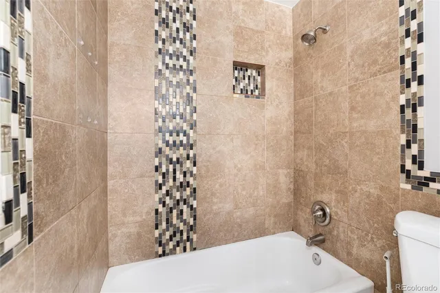 a bathroom with a toilet and a shower curtain