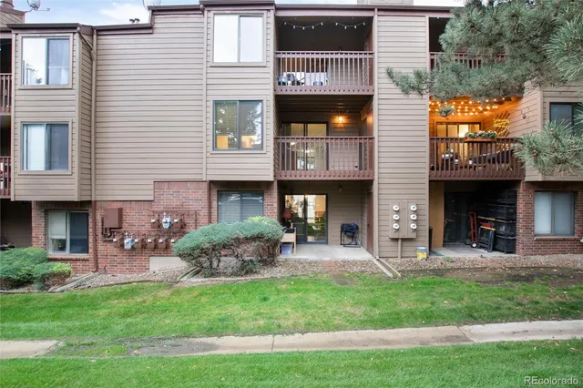 a view of a house with a yard and sitting area