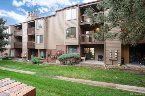 a view of a house with a yard and sitting area
