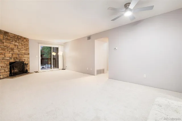 a view of an empty room with a fireplace