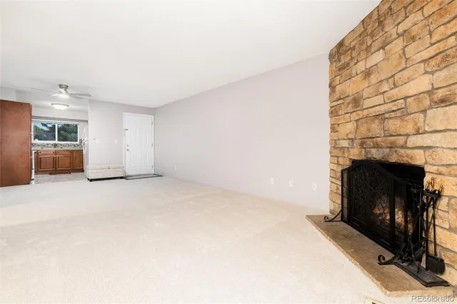 a view of an empty room with a fireplace