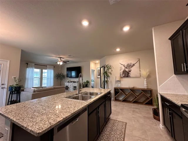 a kitchen with sink and refrigerator